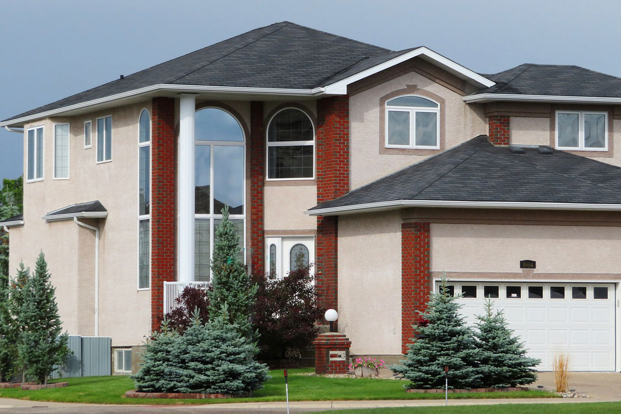Two-story house with brick columns and landscaped front garden